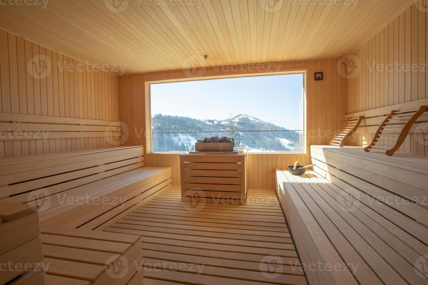 Empty wooden sauna room with traditional sauna accessories photo