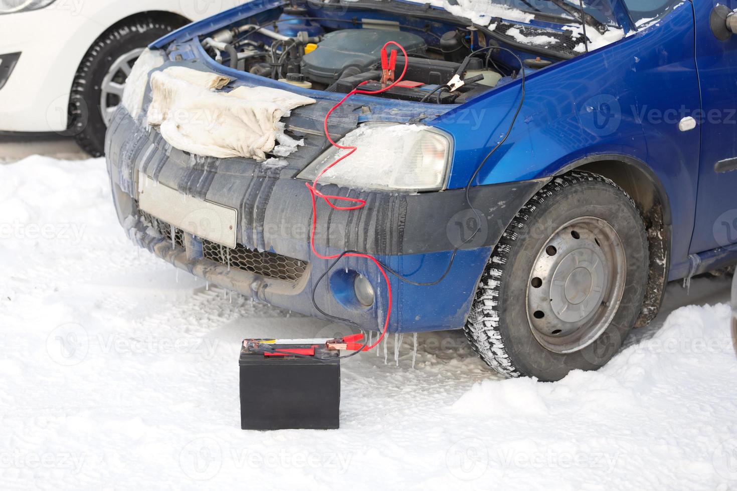 conectar cables de alto voltaje a la batería del automóvil. cargando la batería descargada del automóvil foto