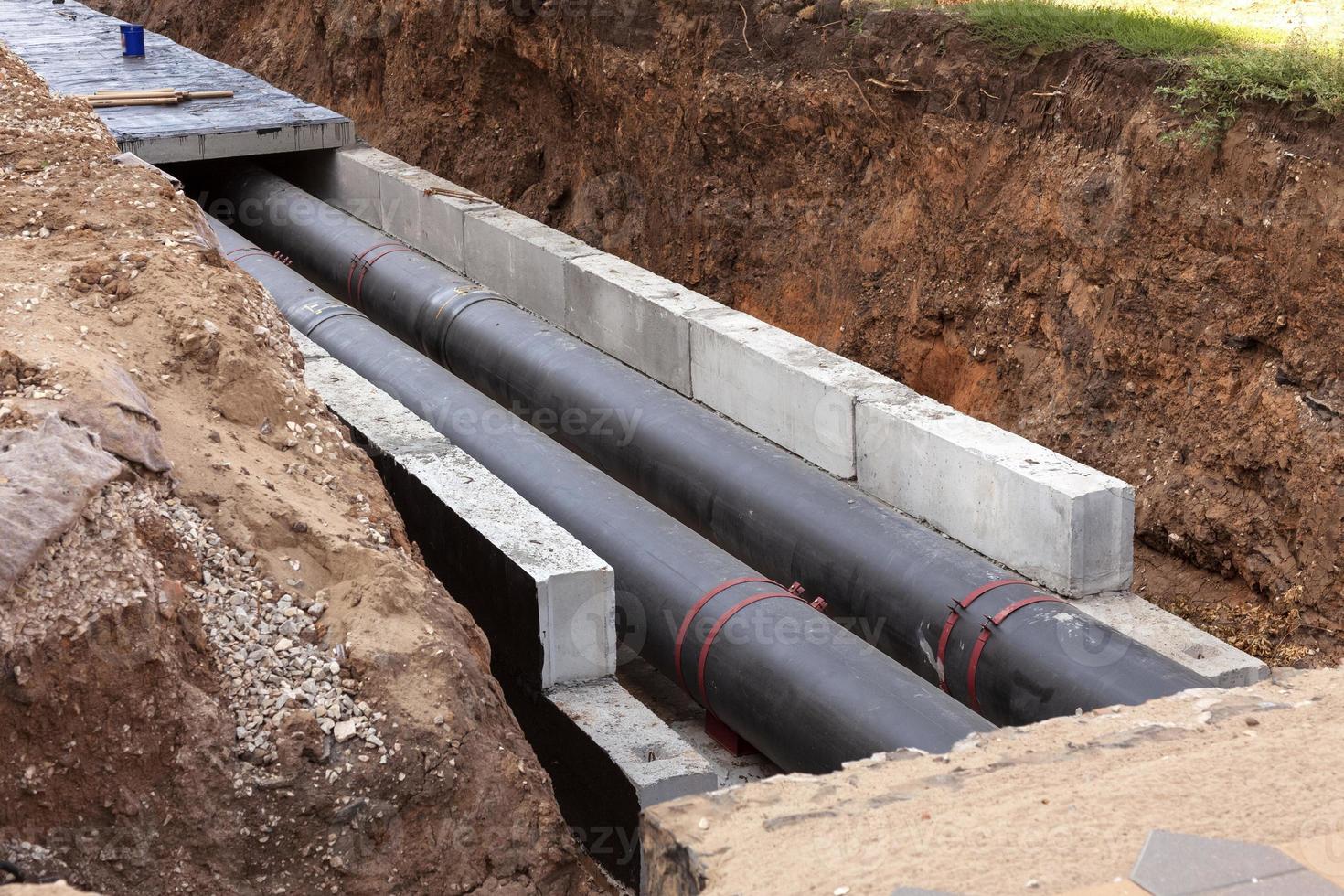 Insulated pipes in the trench. Water main reconstruction and replacement. photo