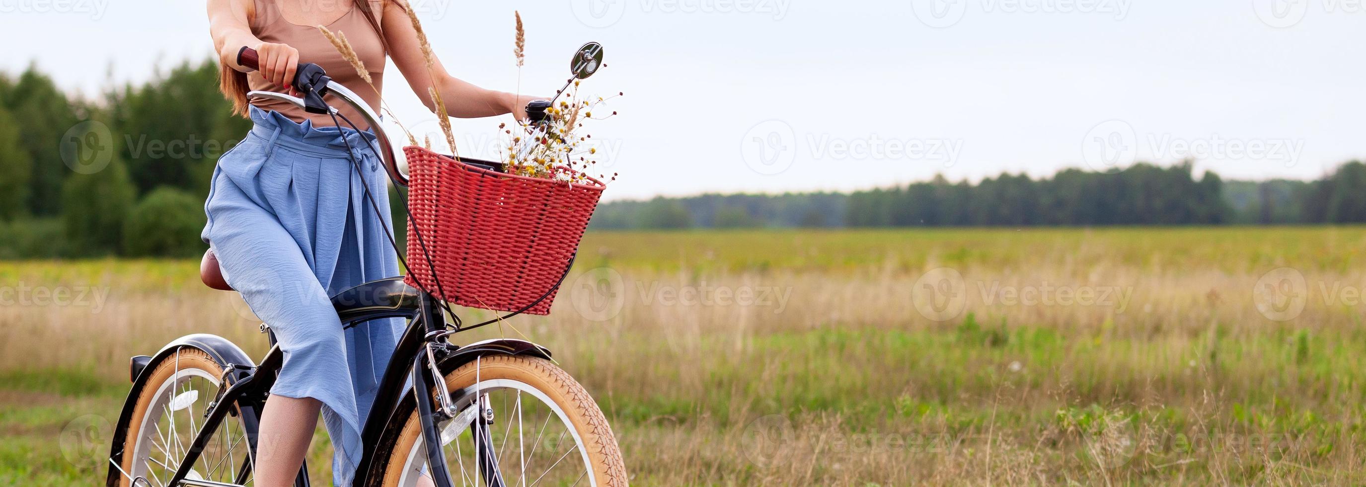 Girl on a bike in the countryside photo