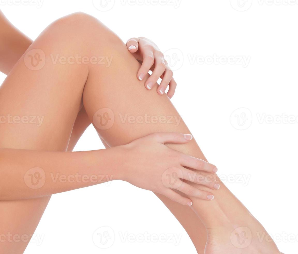 Woman sitting on the floor touch leg by hand photo