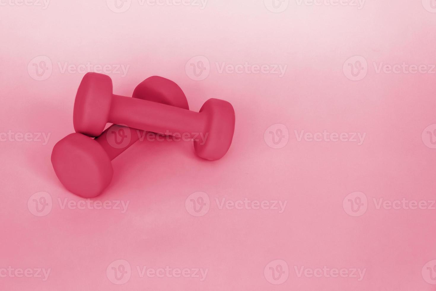 mancuernas verdes para deportes sobre un fondo rosa. deporte, nutrición deportiva, alimentación saludable, dieta. espacio para el texto. foto