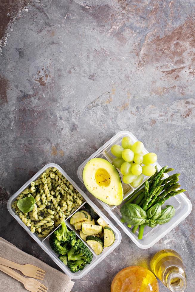 Vegan meal prep containers with pasta and vegetables photo