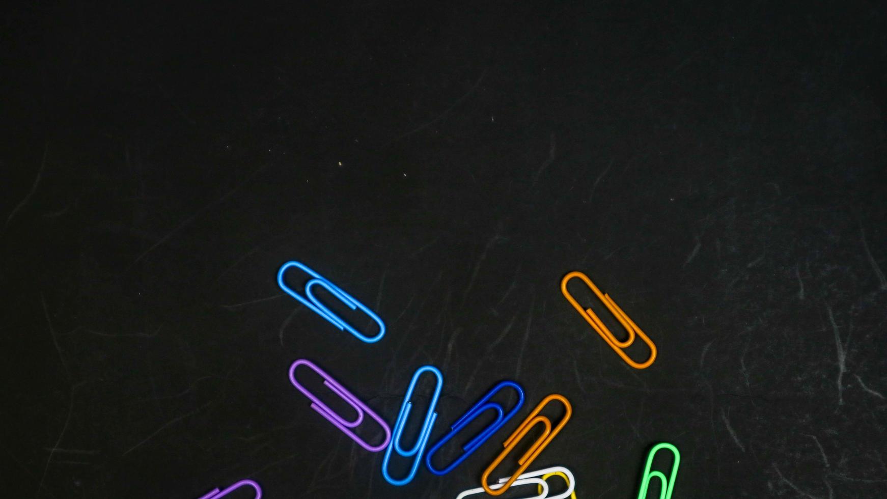 Paper clip isolated on a black background photo