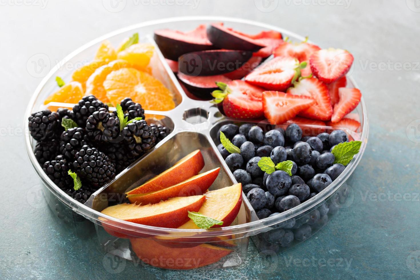 Assorted fruit and berries on a plate photo