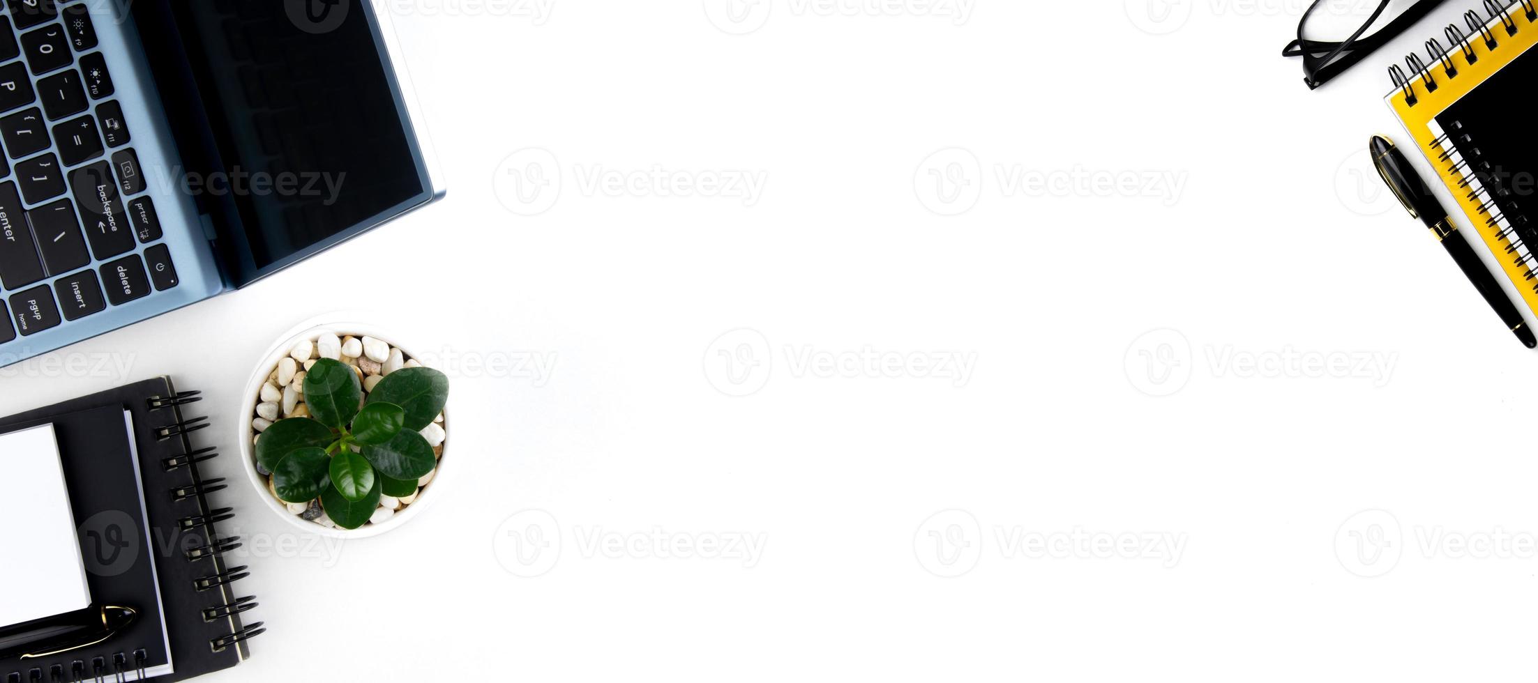 top view of modern white office desk with computer keyboard, blank notebook page and other equipment on white background. Workspace concept, workspace management style, business design space with copy photo