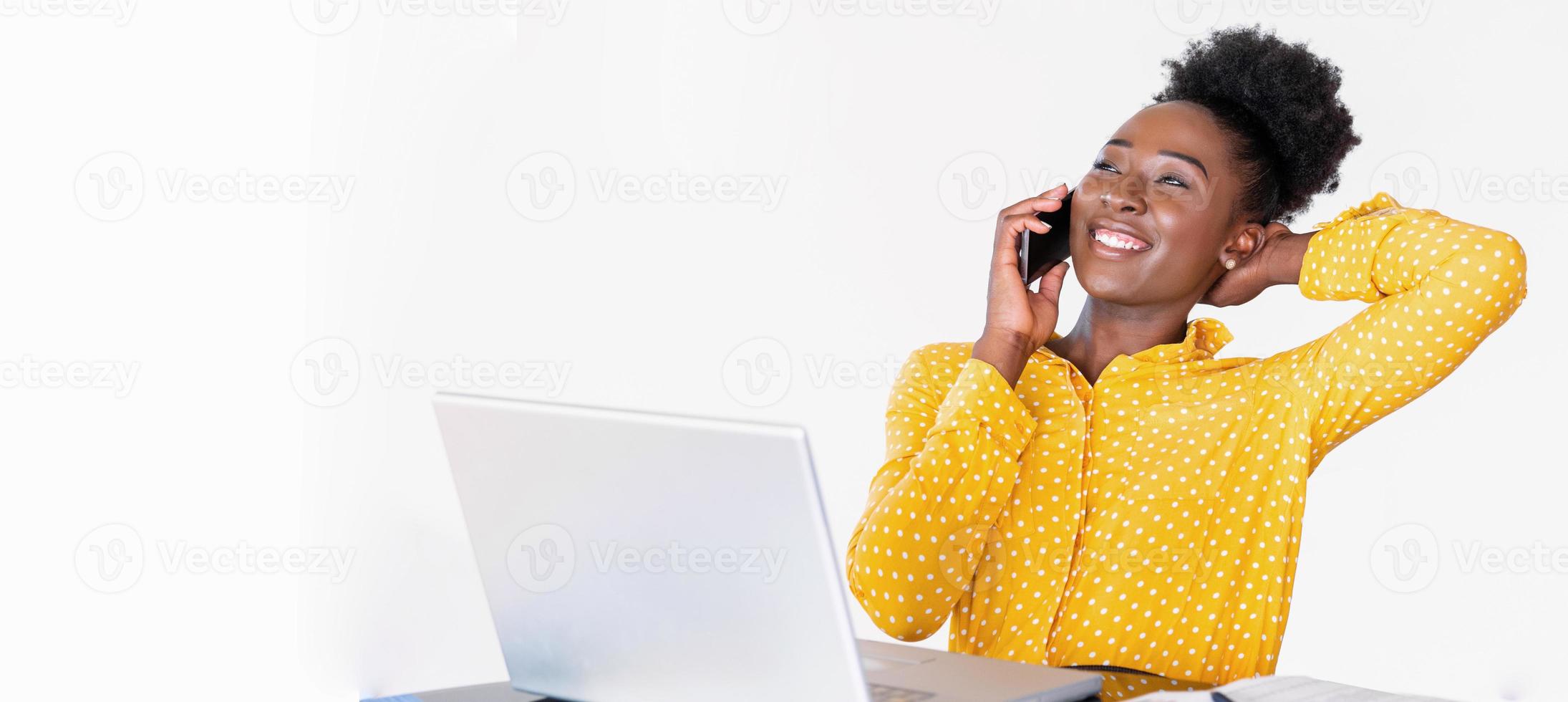 Trendy business woman talking on phone, home-office, banner template. African American woman at training seminar, female business leader going true paperwork at her office photo