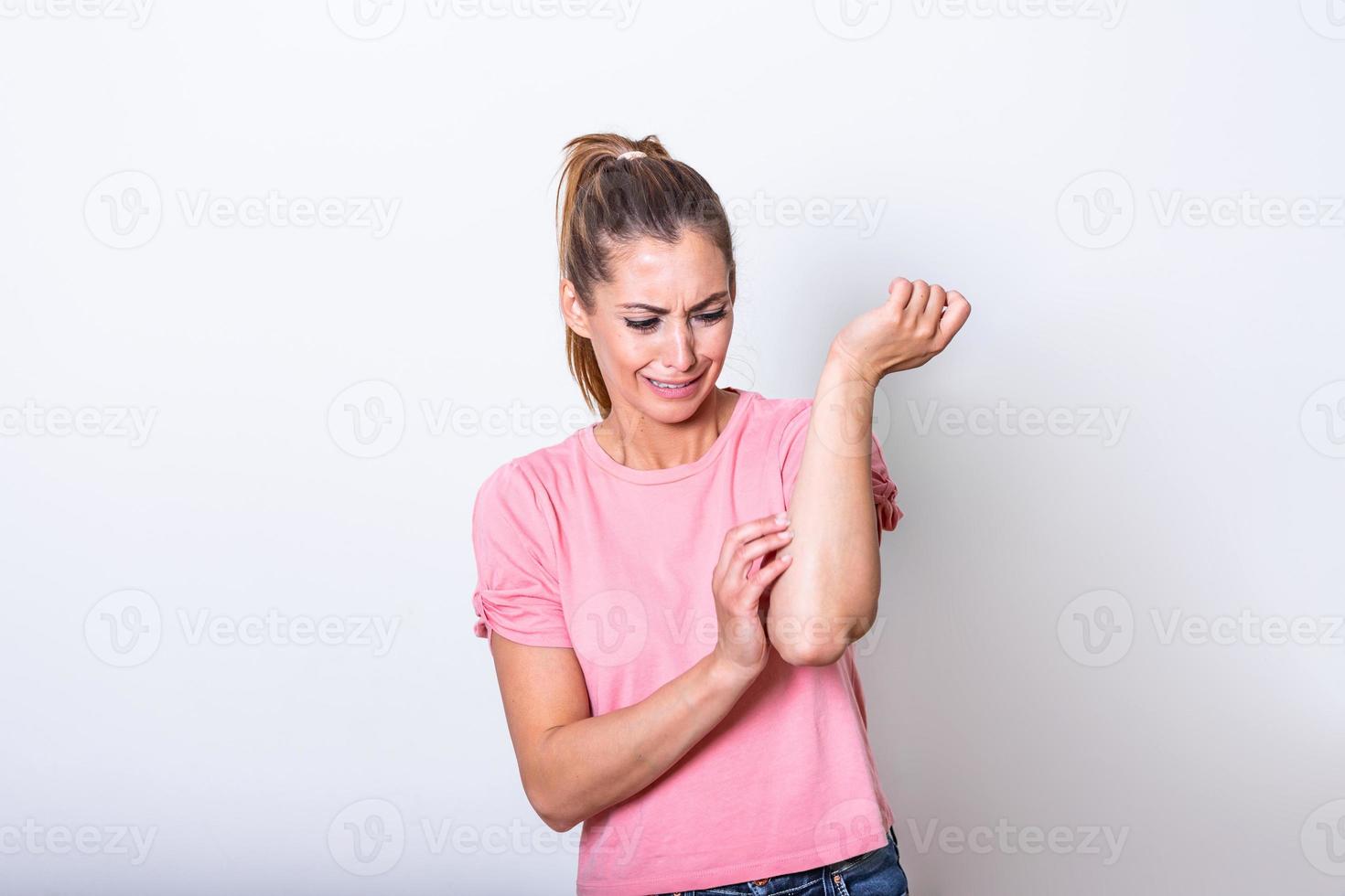 Health problem, skin diseases. Young woman scratching her itchy arm with allergy rash. Woman scratching her arm. Woman scratching arm indoors, space for text. Allergy symptoms photo