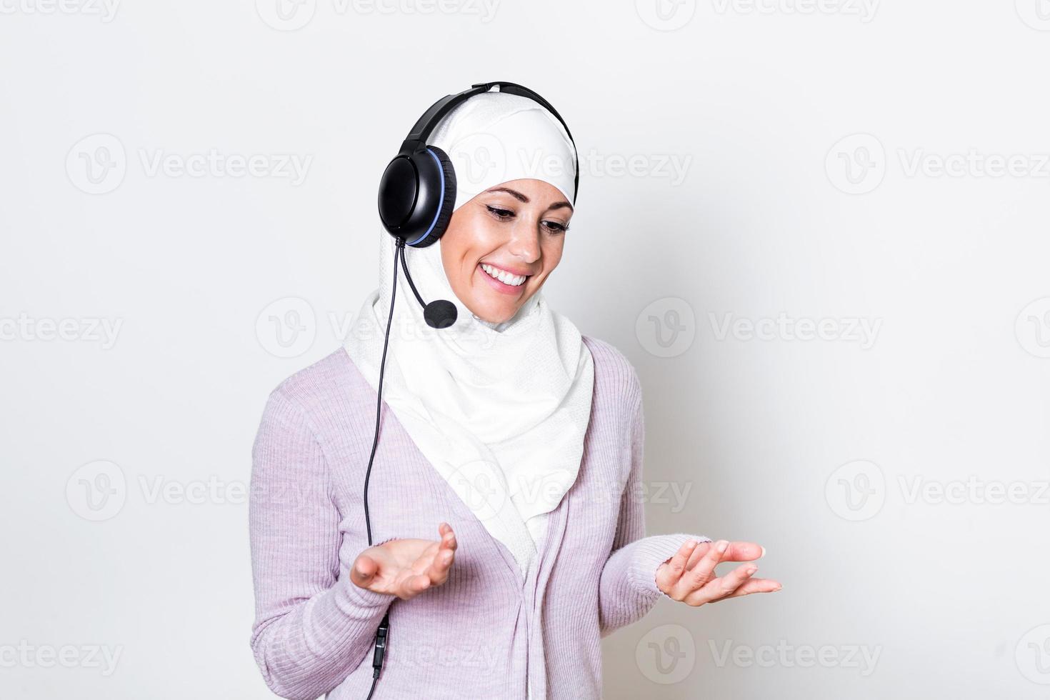 Arab middle eastern businesswoman with headphones customer representative business woman with phone headset helping and supporting online with customer in modern call centre photo