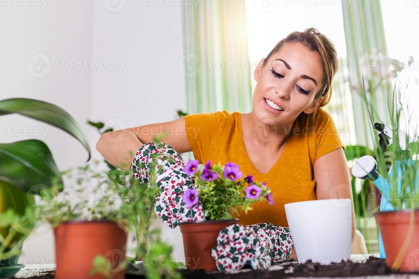 mujer preparando flores para plantar. jardinero plantando flores en maceta. mujer joven preparando flores para plantar durante el trabajo de jardinería. personas, jardinería, plantación de flores y concepto de profesión. foto