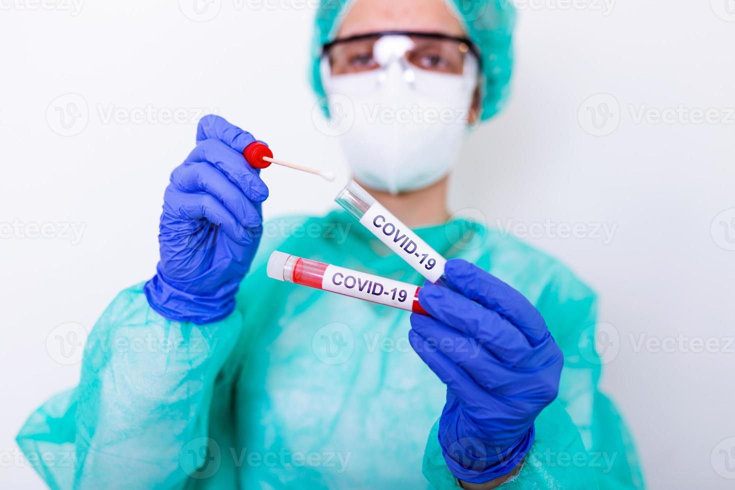 COVID-19 Nasal swab laboratory test in hospital lab, Nurse holding test tube with blood for 2019-nCoV analyzing. Novel Chinese Coronavirus blood test Concept. photo