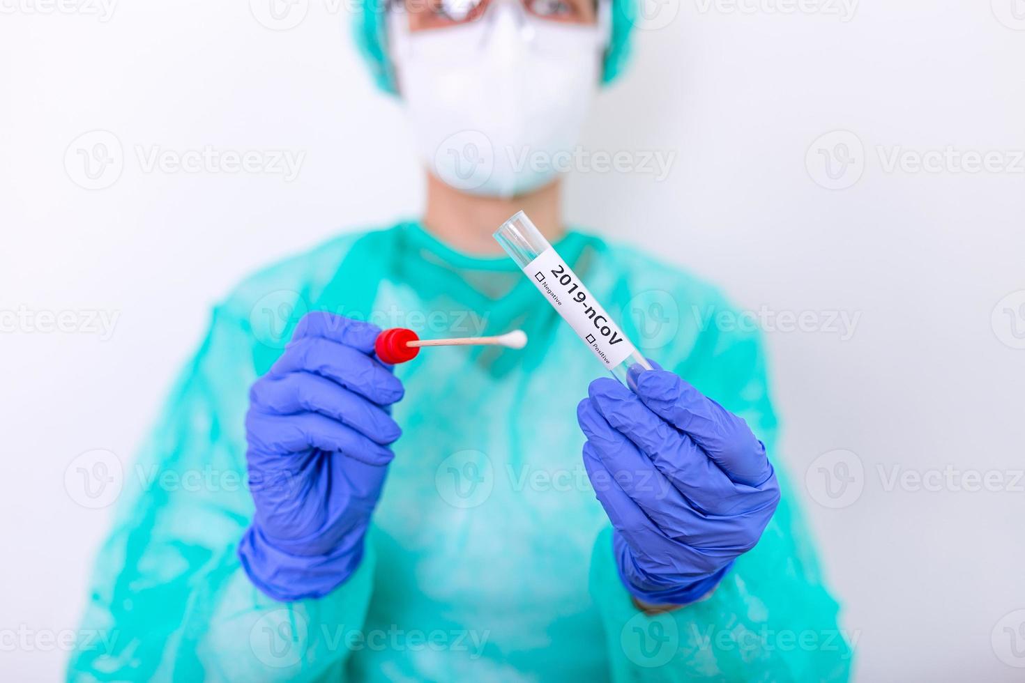 Testing for presence of coronavirus. Tube containing a swab sample that has tested positive for COVID-19. photo