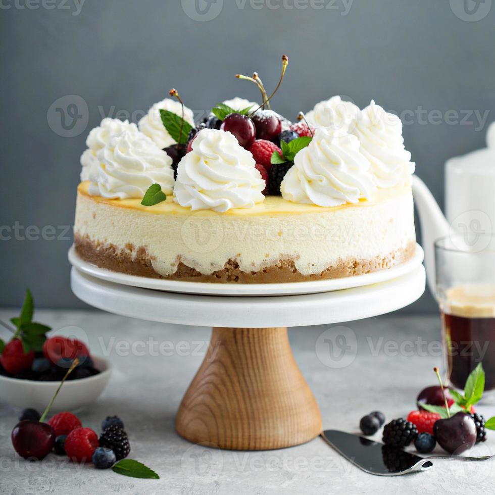 Classic New York cheesecake decorated with whipped cream photo