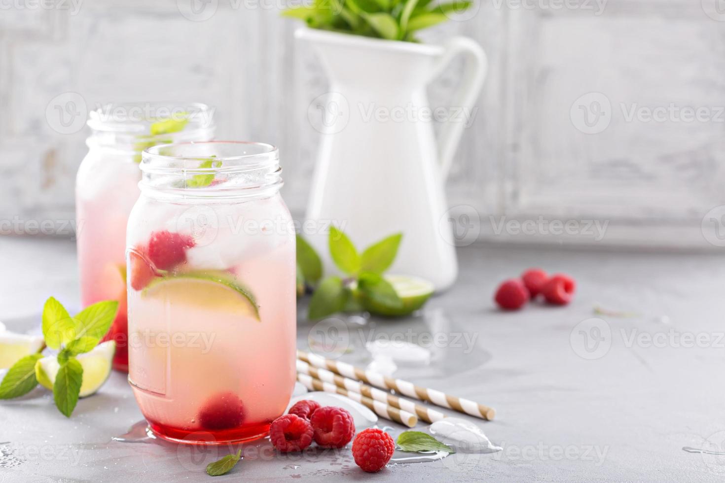 Cold green iced tea with lime and raspberry photo