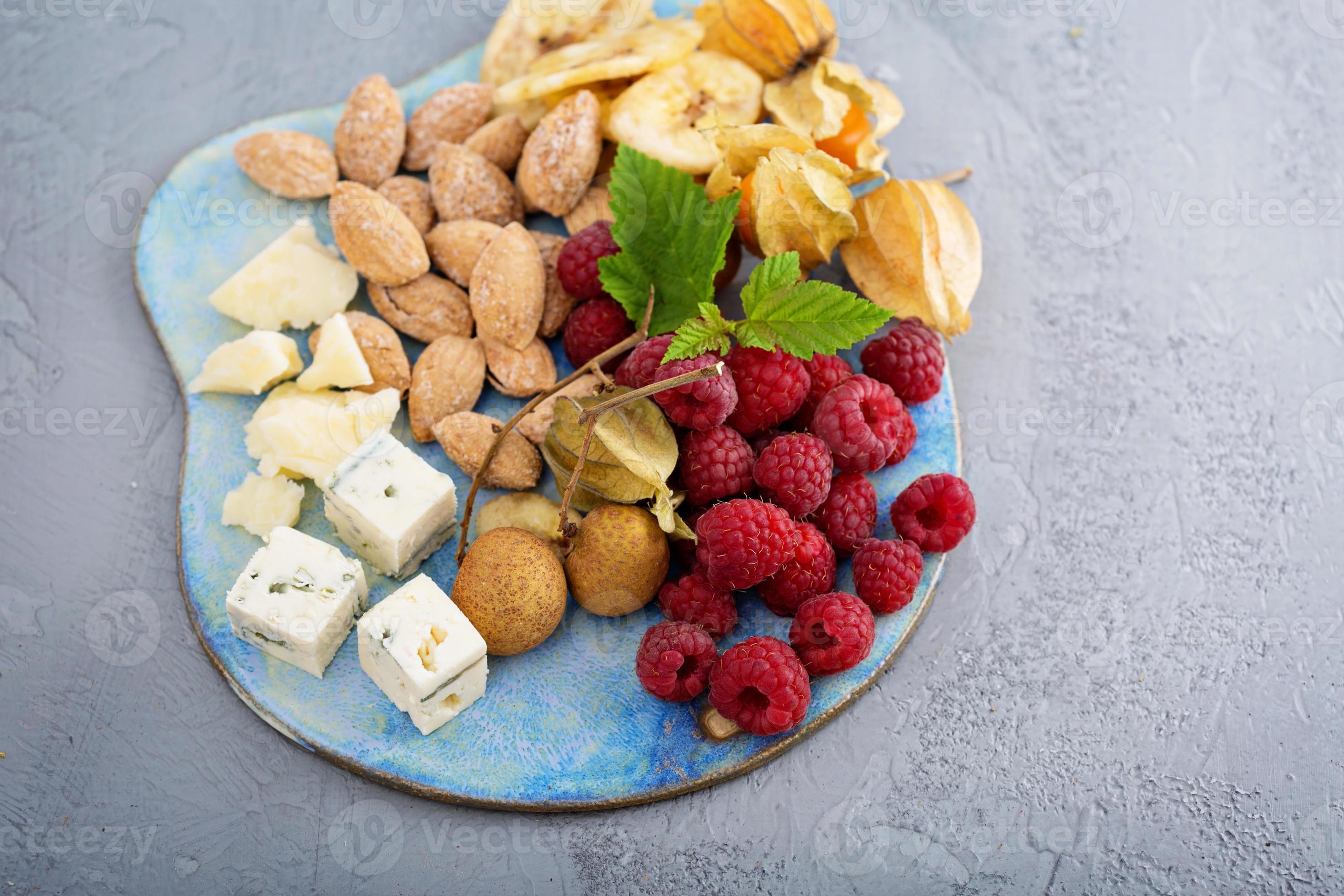Fruit and nuts cheese board 15747318 Stock Photo at Vecteezy