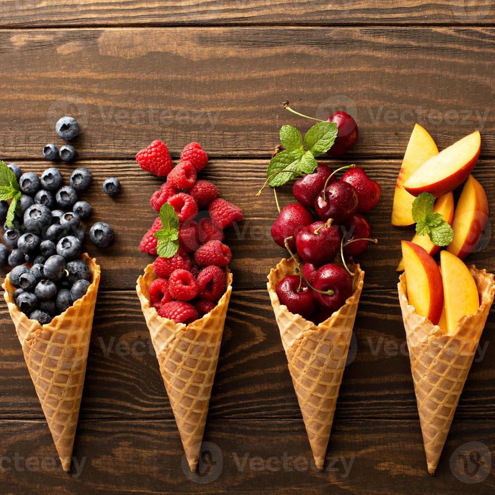 Fresh fruit and berries in waffle cones photo