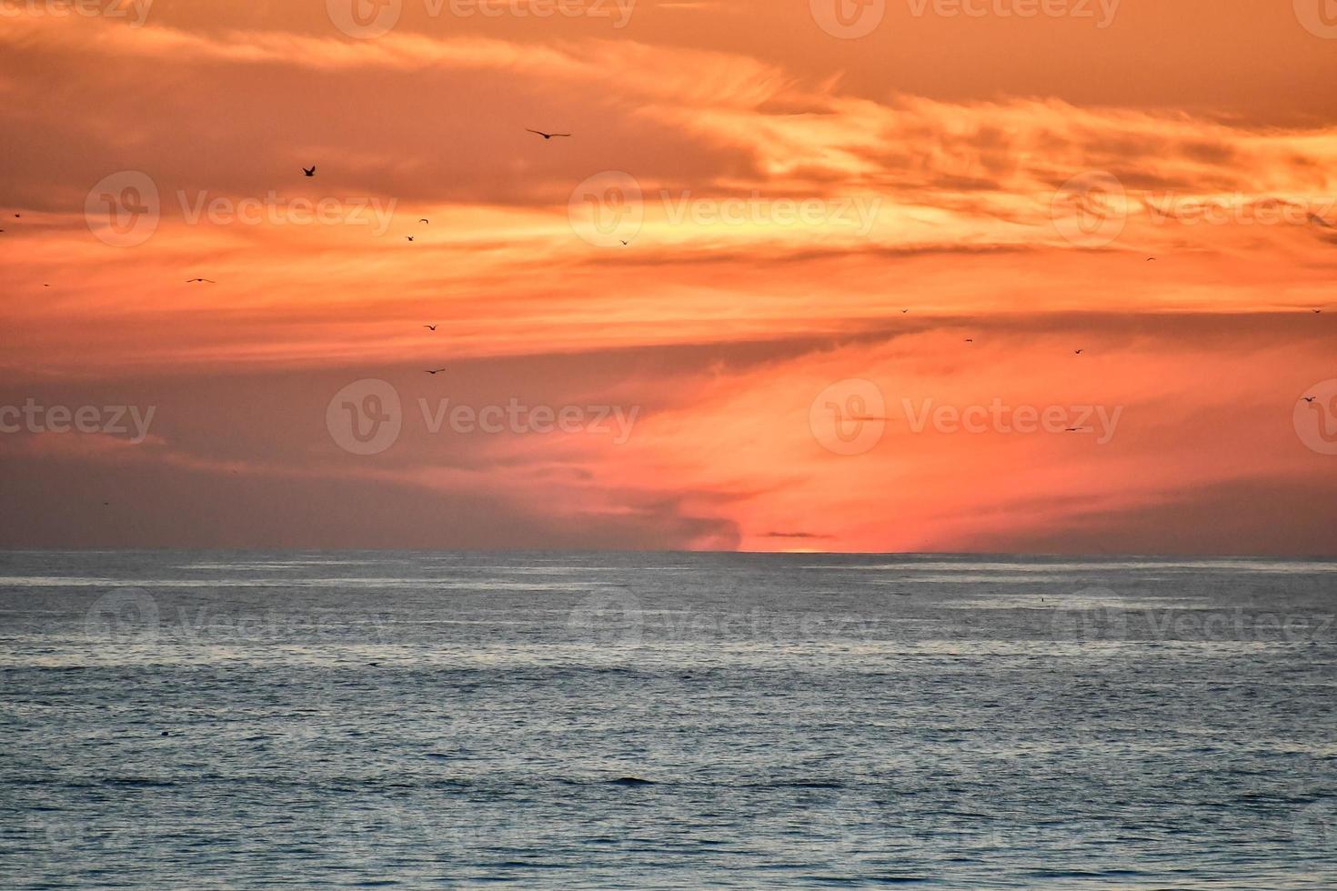 Sunset over the ocean photo