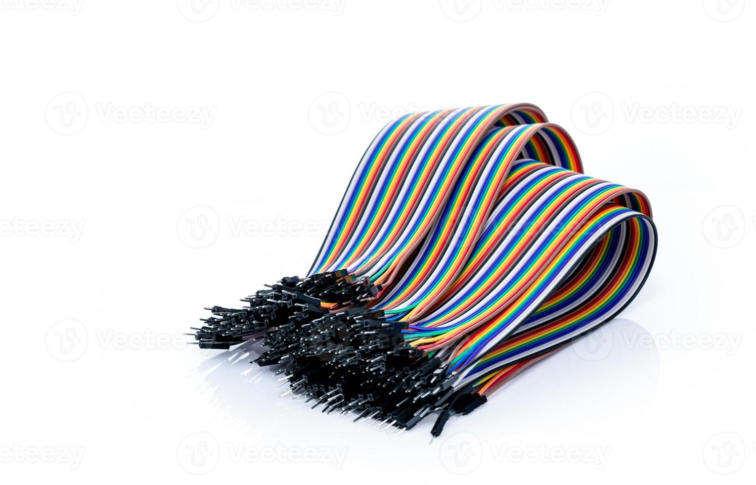 Ribbon cable or multi-wire planar cable on white background. Flat ribbon cable with pin connectors. Multi-colored ribbon computer connecting cable. Connecting pins. Electronic component of computer. photo