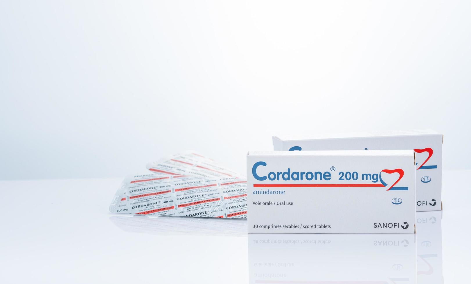 CHONBURI, THAILAND-SEPTEMBER 23, 2022 Cordarone in blister pack and paper box packaging. Sanofi product. Amiodarone white tablet pills for treatment arrhythmias. Prescription drugs. Pharmaceutics. photo