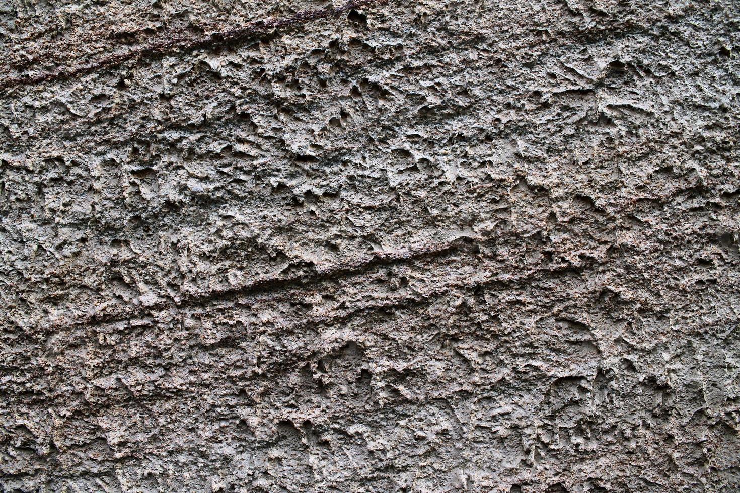 Detailed view on aged concrete walls with cracks and a lot of structure in high resolution photo