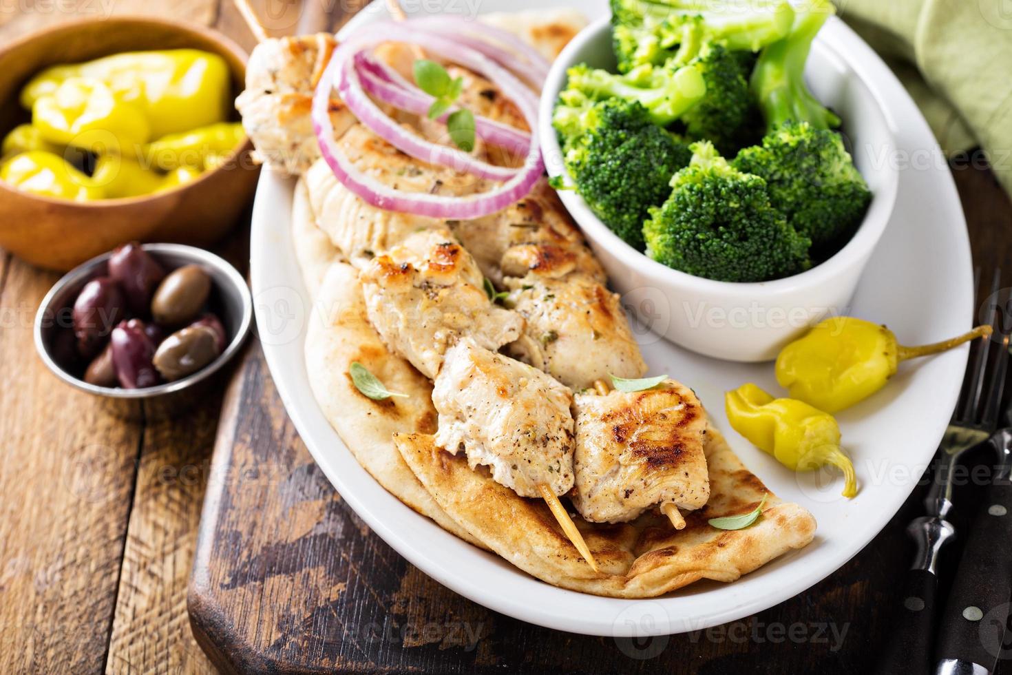 Grilled chicken kebabs on a pita photo