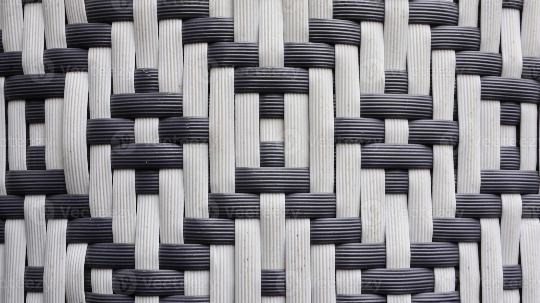 Knitted synthetic rattan material with traditional black and white texture for wallpaper and background. photo