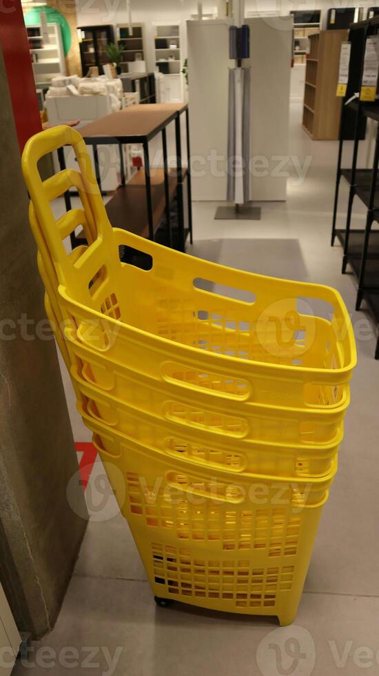 Yellow shopping baskets at shopping mall. photo