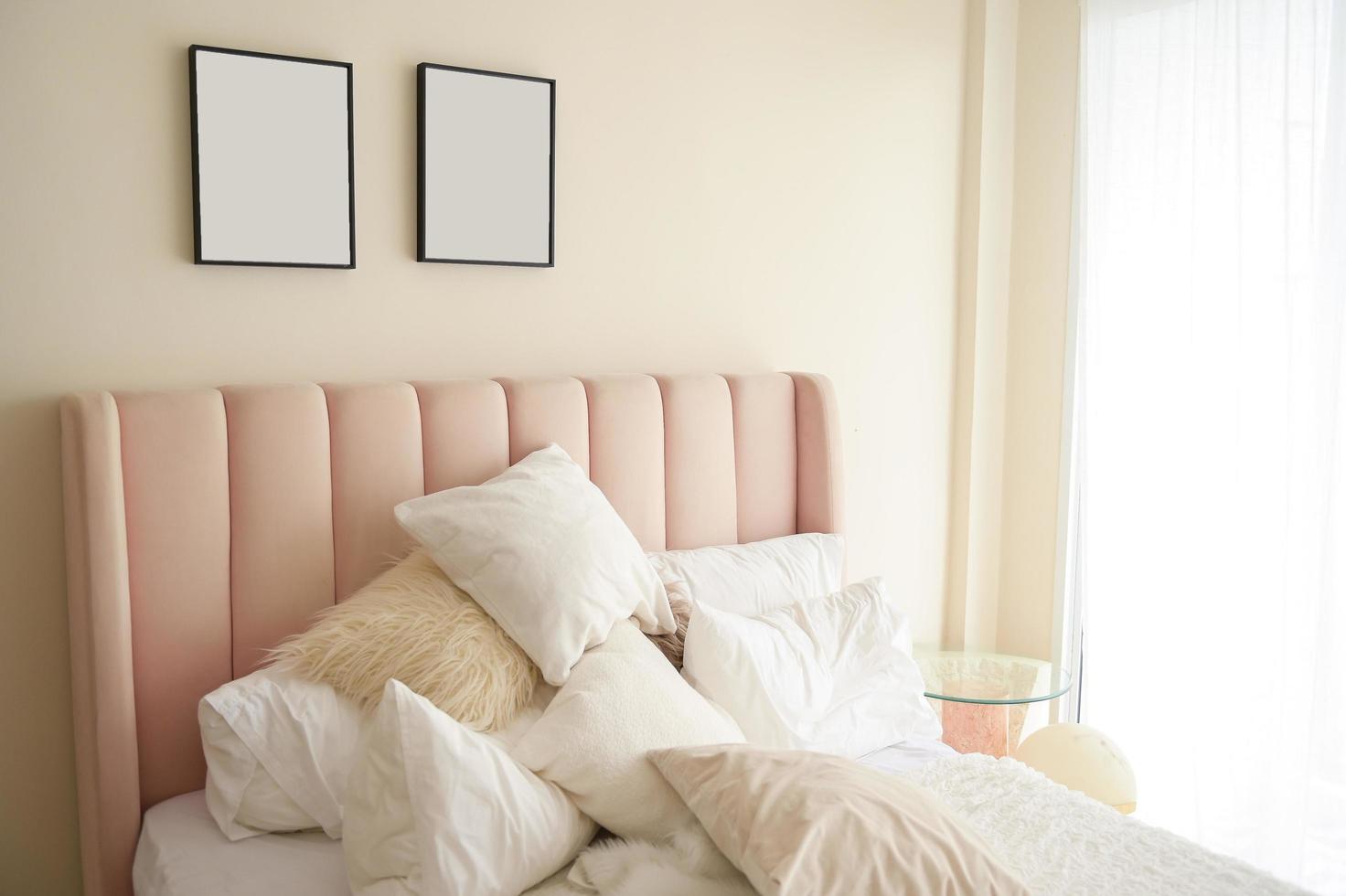 Warm and cozy interior of bedding room space with pink bed, mock up poster frame. Cozy home decor. photo