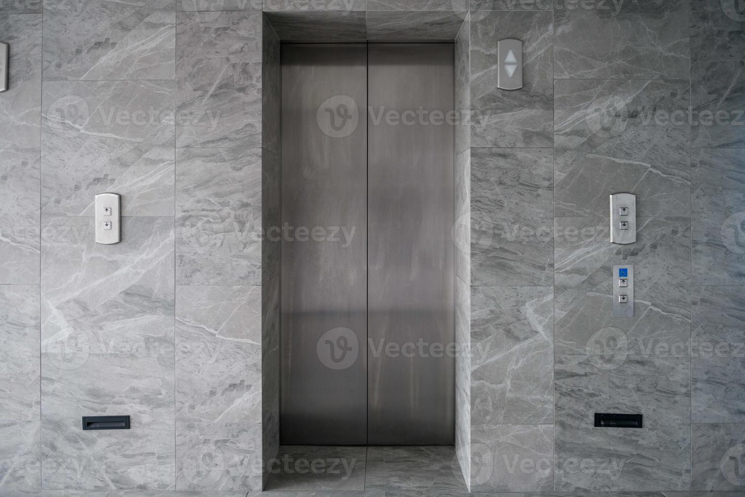 modern metal elevators in hotel lobby photo