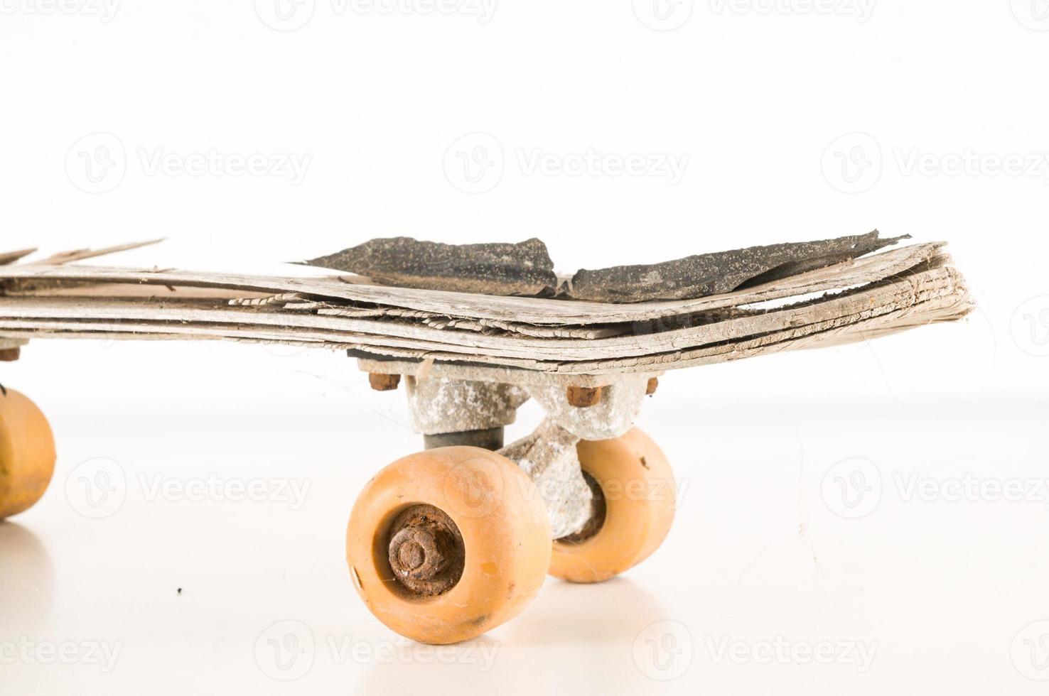 Old skateboard on white background photo