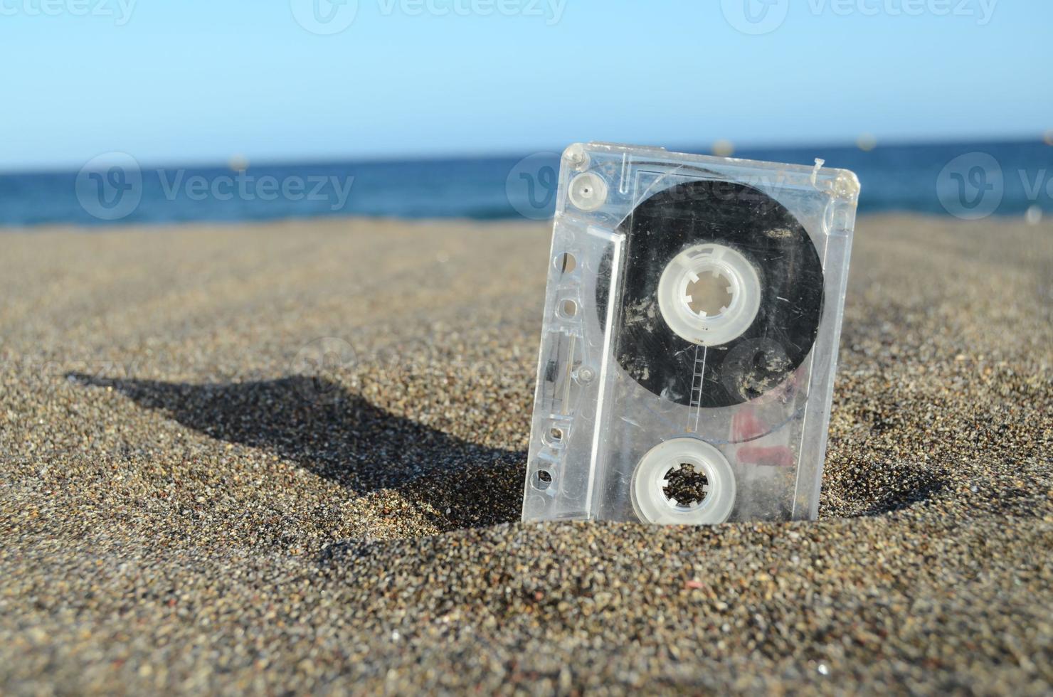 Ancient Retro Musicassette on the Sand photo
