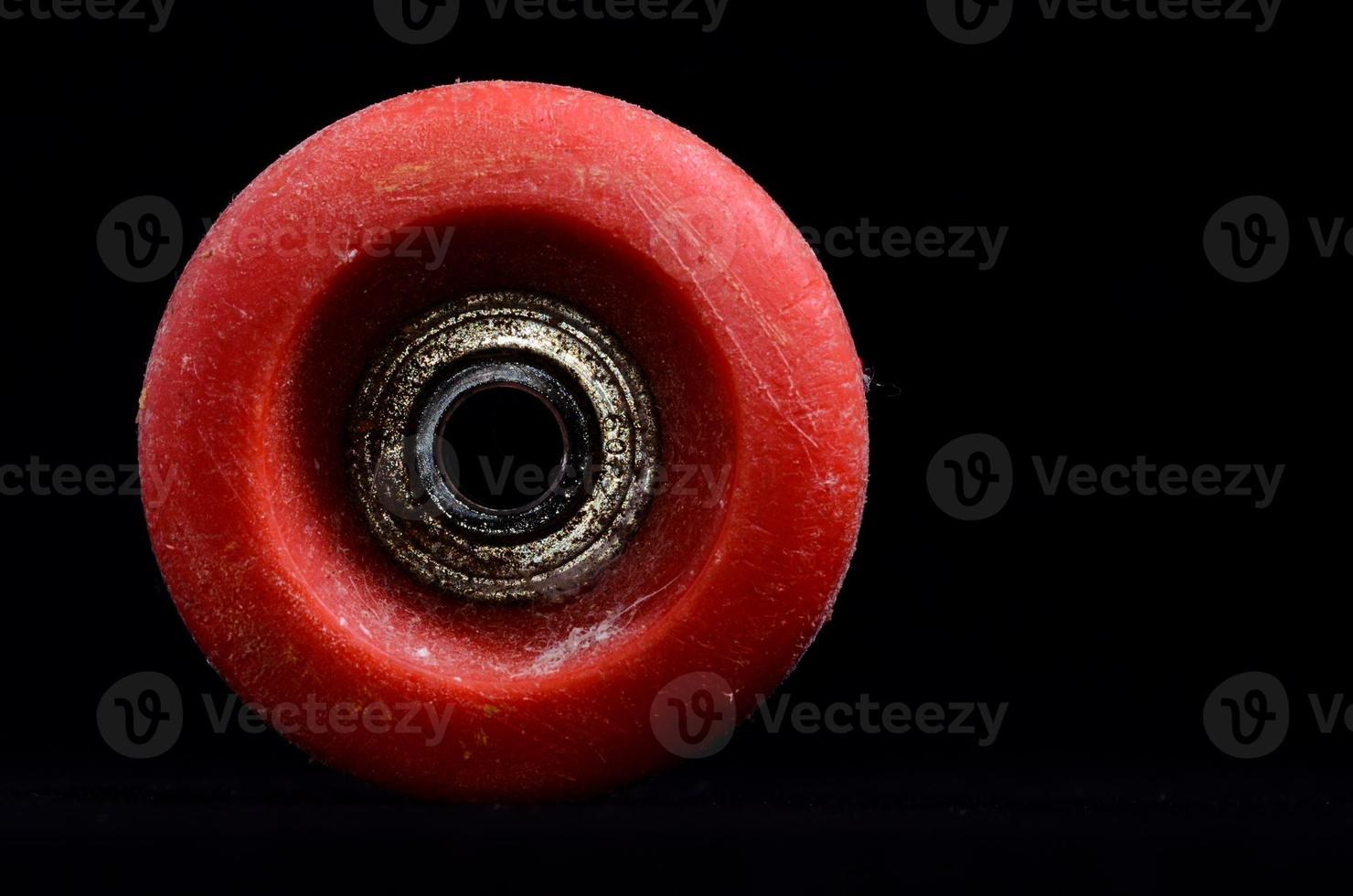 Old Vintage Consumed Skate Wheel on black background photo