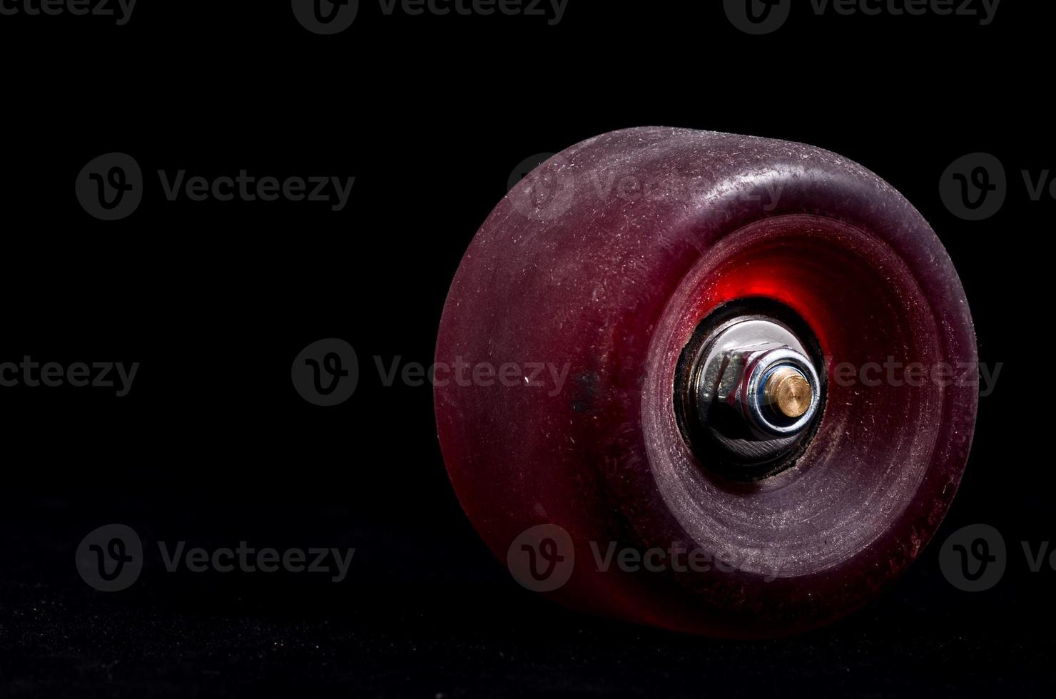 Old Vintage Consumed Skate Wheel on black background photo