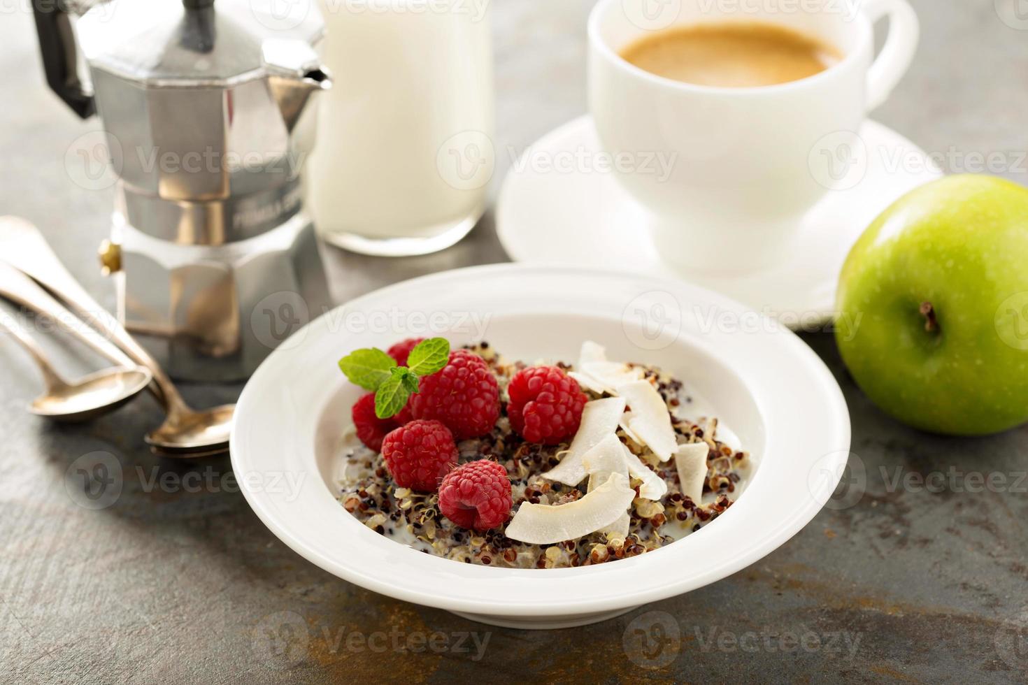 Quinoa porridge with raspberry and coconut flakes photo