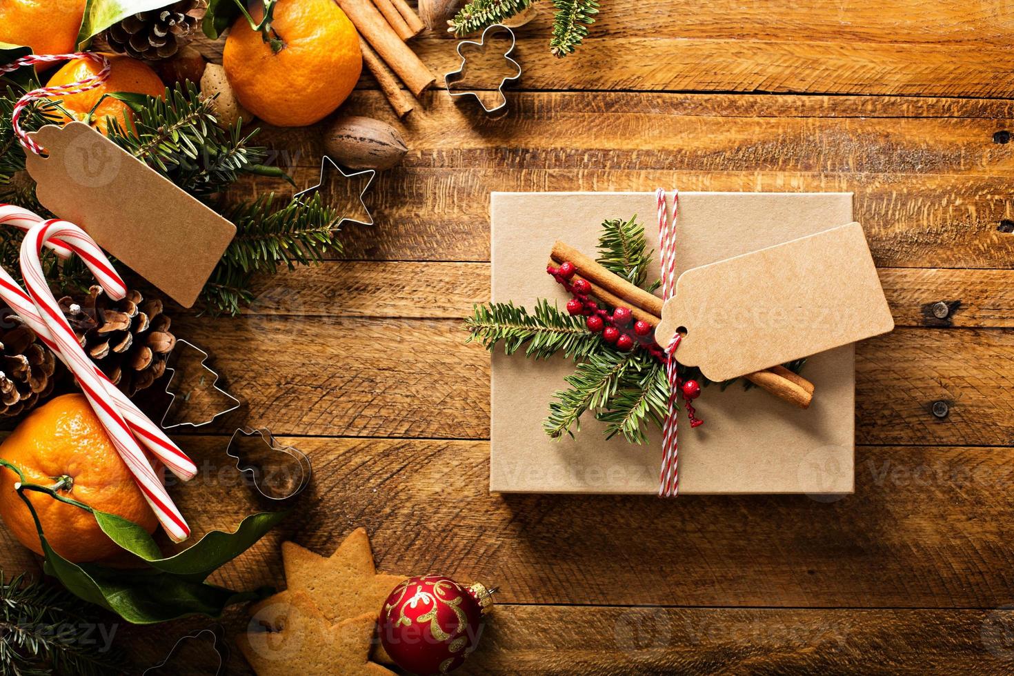 Christmas present with oranges, candy canes and decorations photo