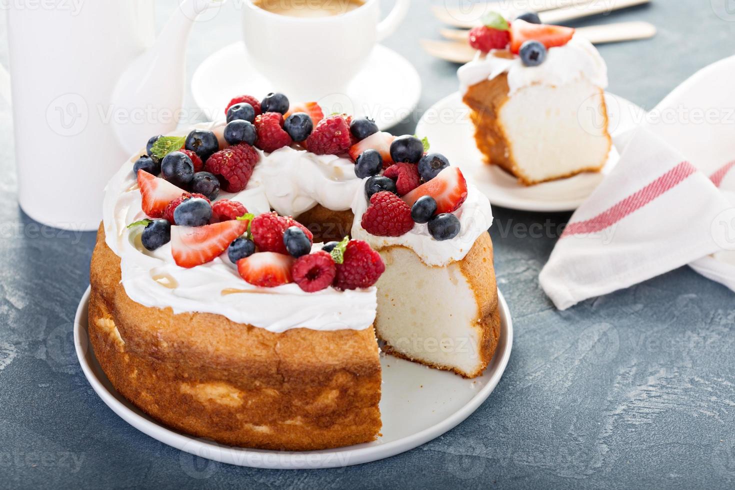 Angel food cake with whipped cream and berries photo