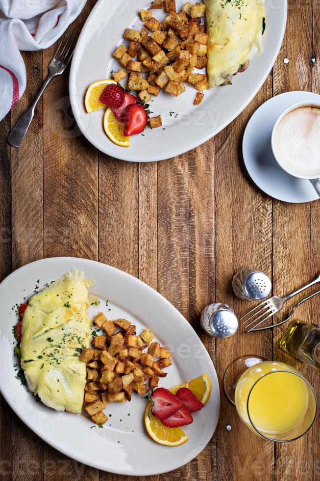 Breakfast table with omelette, coffee and orange juice photo