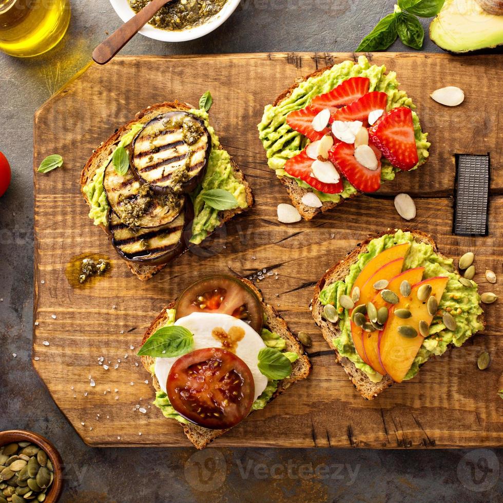 Variety of avocado toasts on a cutting board photo