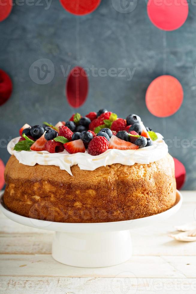 Angel food cake with whipped cream and berries photo