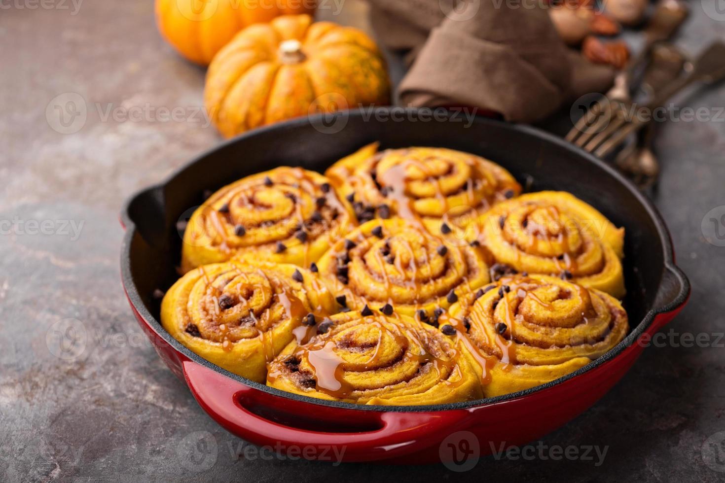Pumpkin cinnamon rolls in a cast iron skillet photo