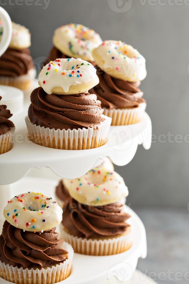 Cupcakes with chocolate frosting and little donuts photo