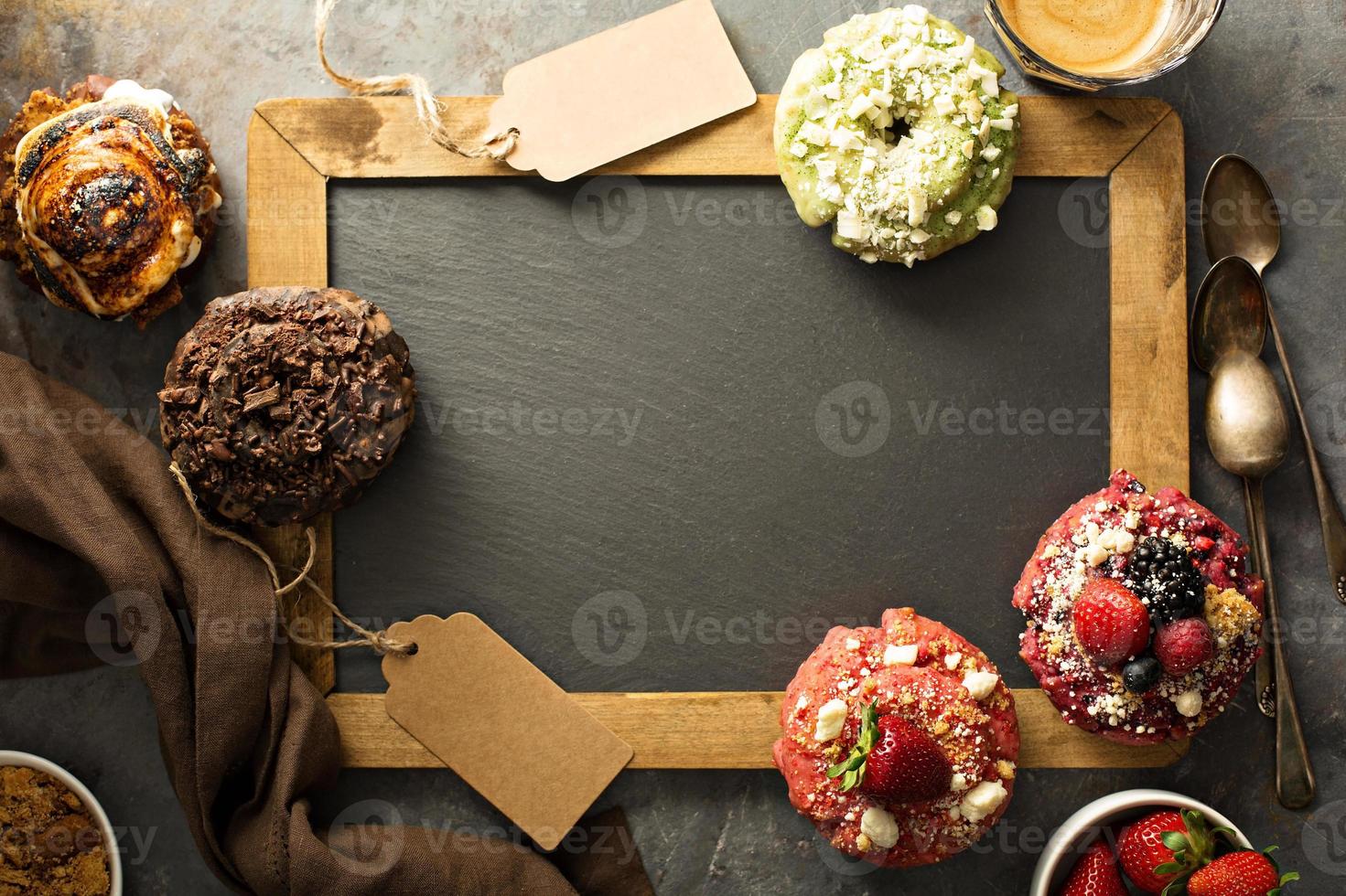 Variety of donuts around a chalkboard photo