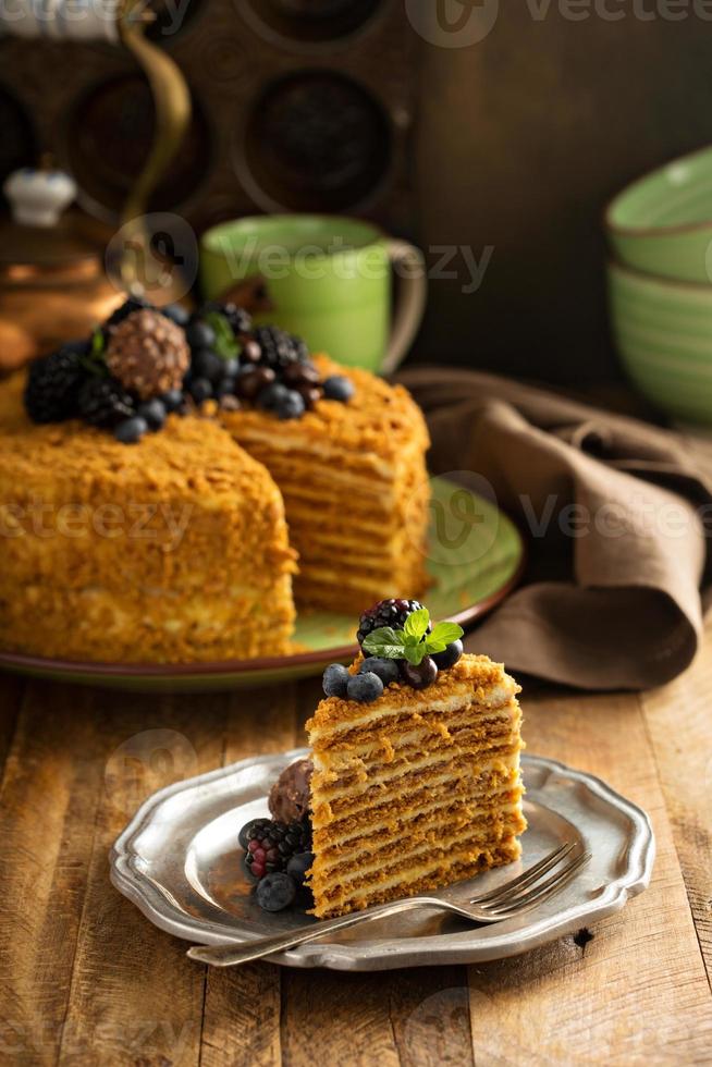 Caramel cake with honey and cream frosting photo