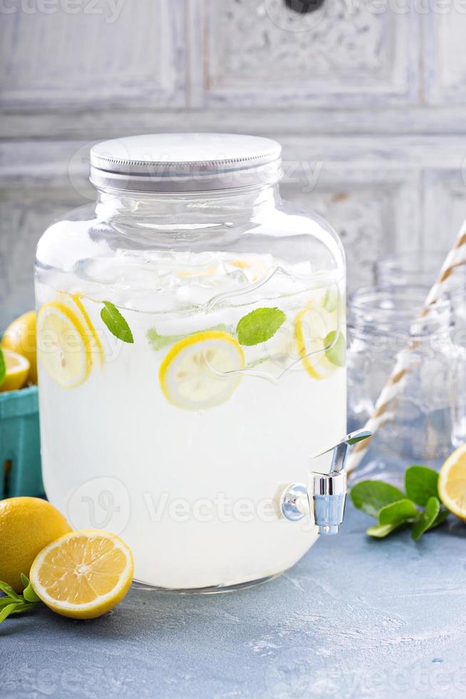 Fresh citrus lemonade in beverage dispenser photo