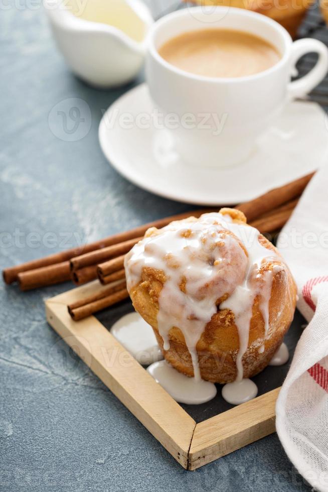 Cinnamon bun with glaze for breakfast photo