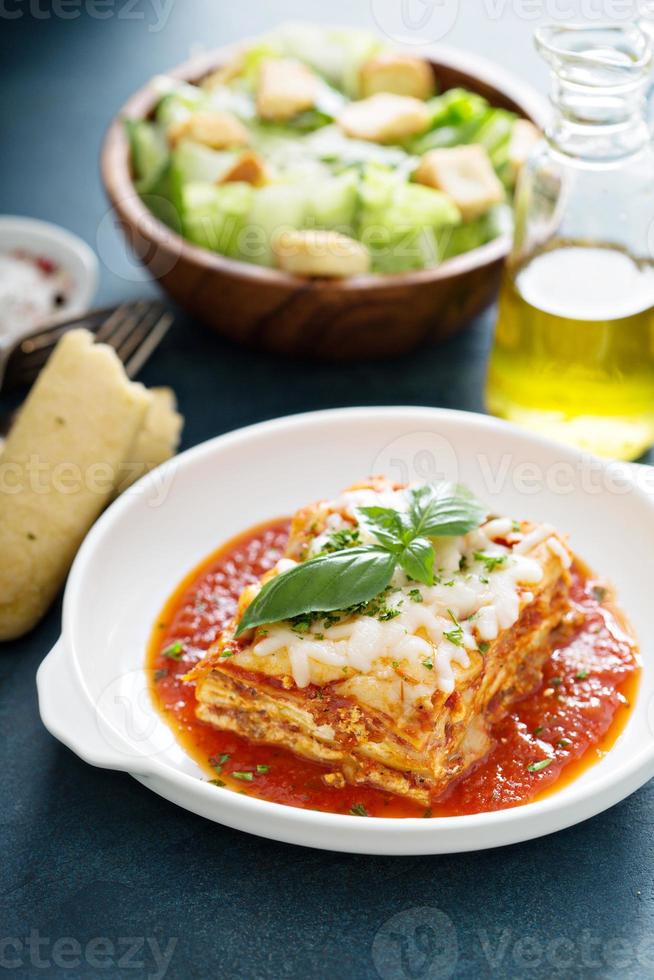 Traditional lasagna on white plate photo