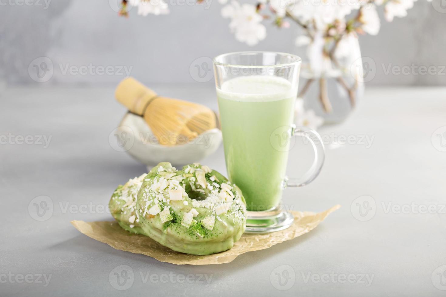 Matcha and white chocolate donuts with tea photo