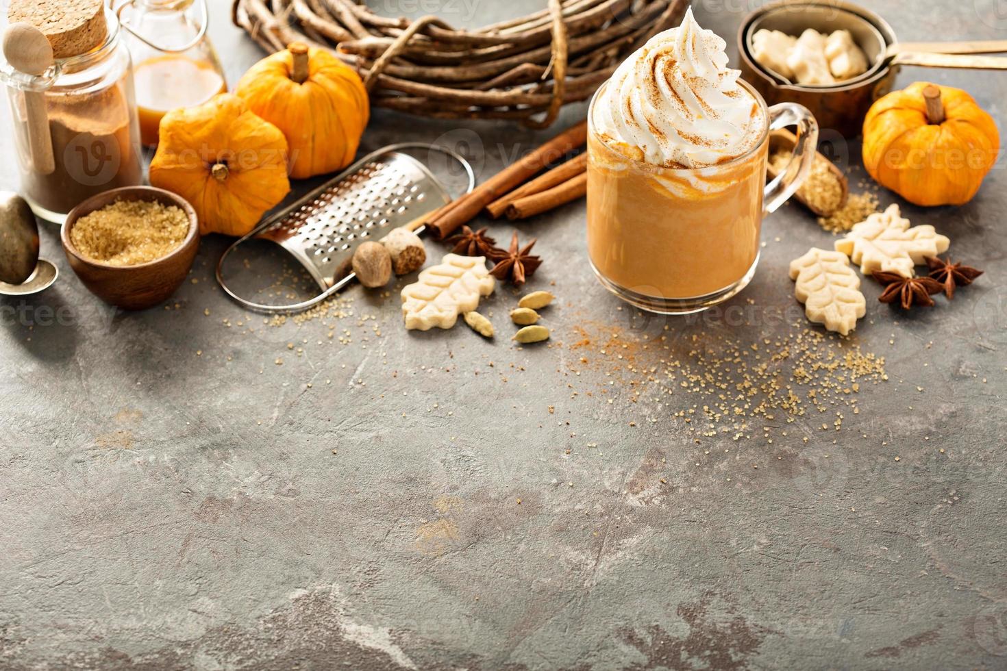 Pumpkin spice latte in a glass mug photo