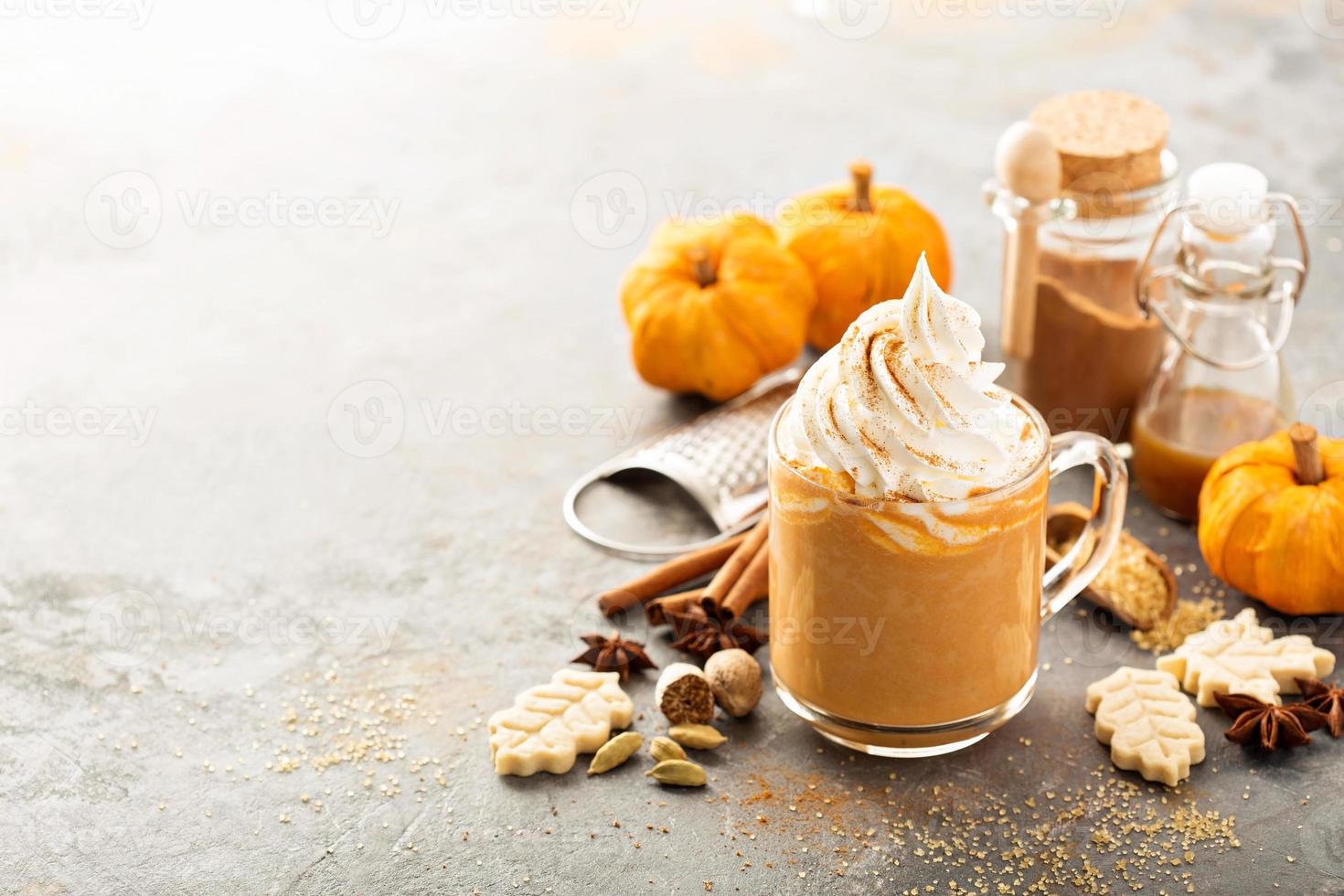 Pumpkin spice latte in a glass mug photo