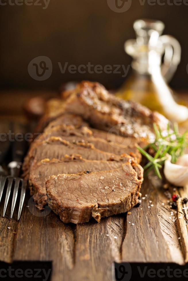 Braised brisket on cutting board photo